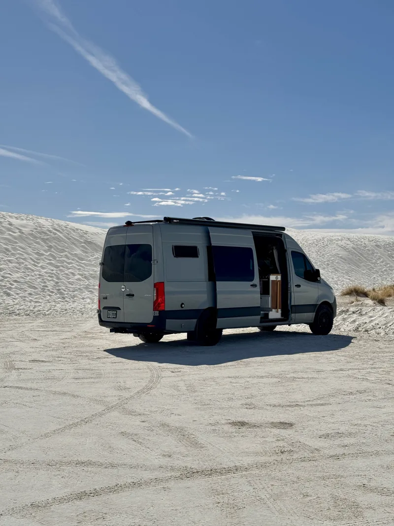 Pebbles parked on bright white sand
