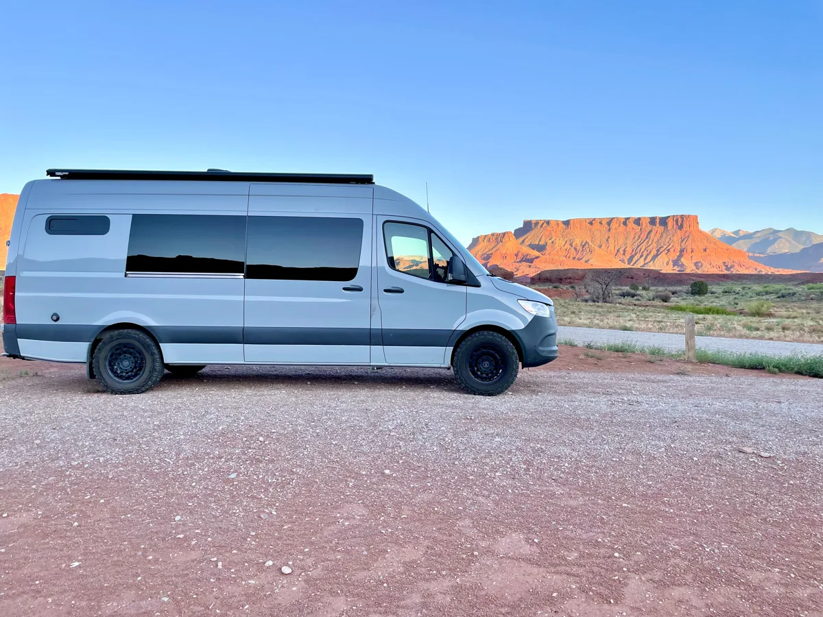 Full side view of Pebbles parked near red rock formations