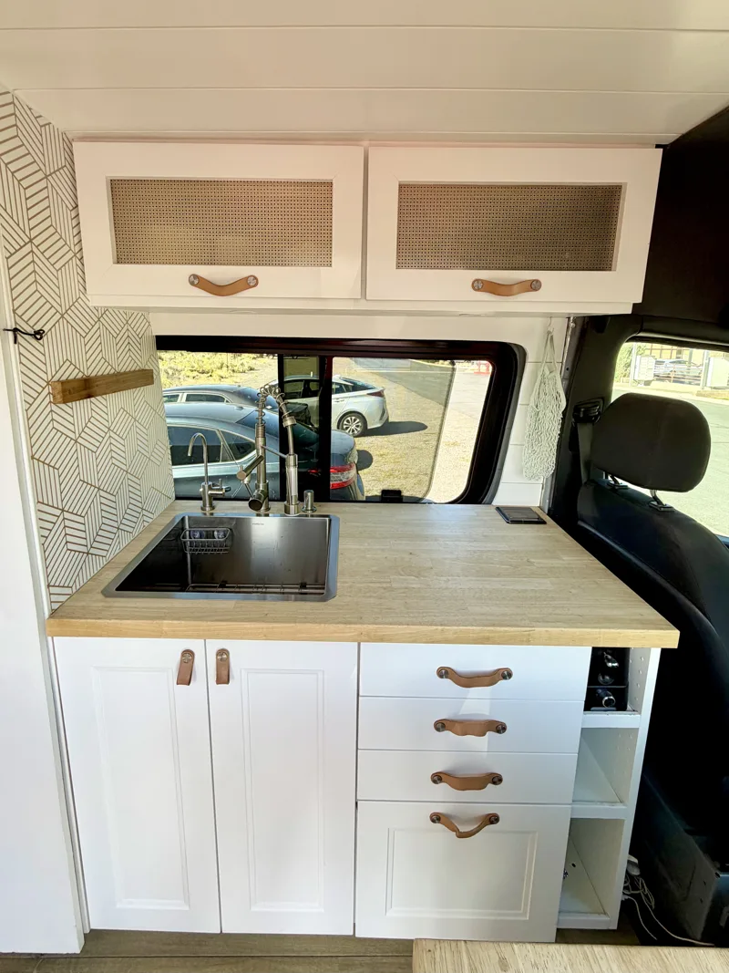 Straight-on view of the kitchen sink and cabinets