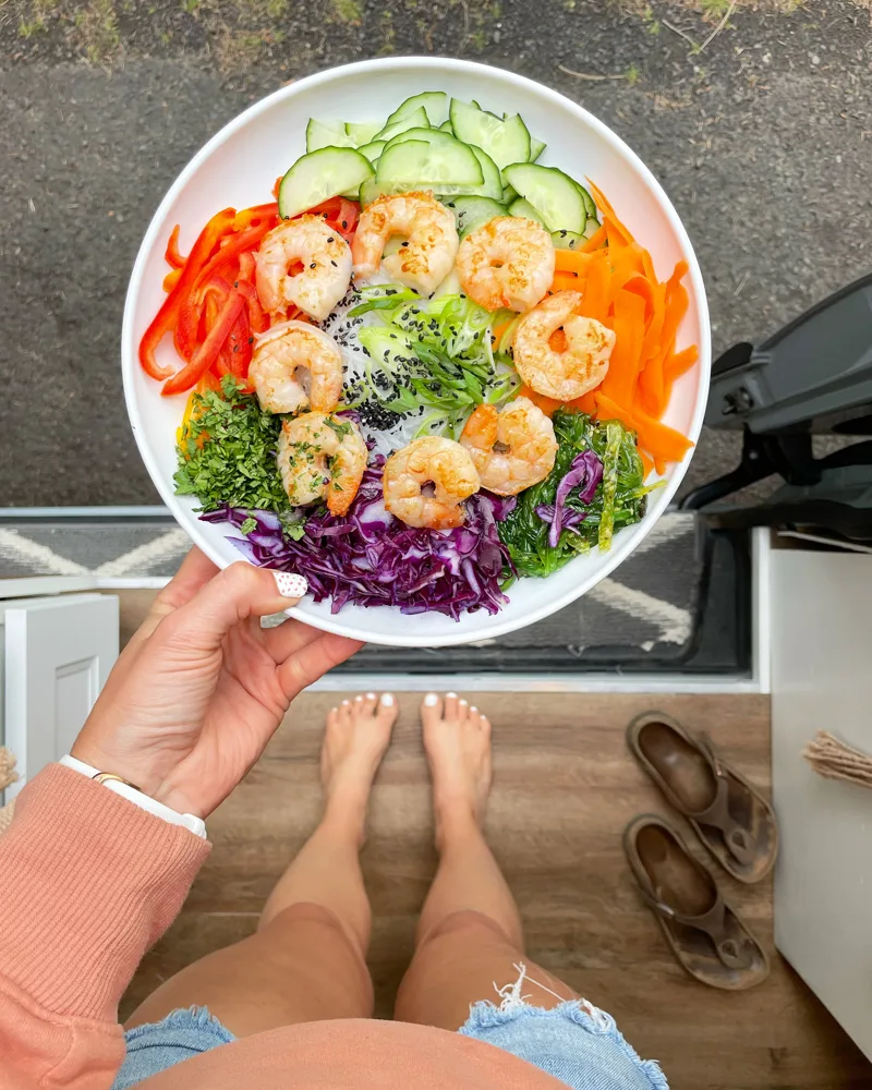 A prepared meal held above the kitchen stove