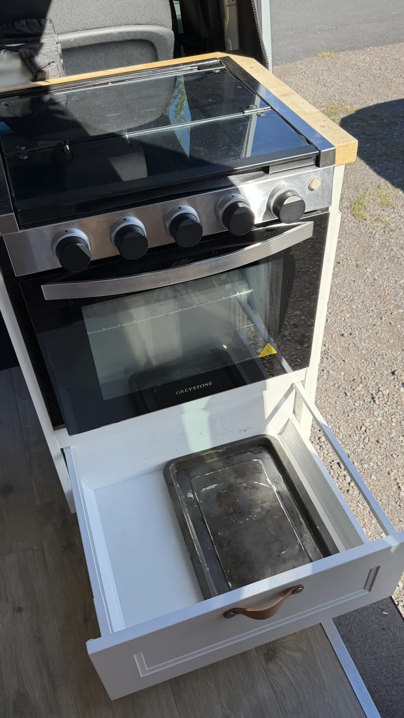 Oven and stovetop with the storage drawer open