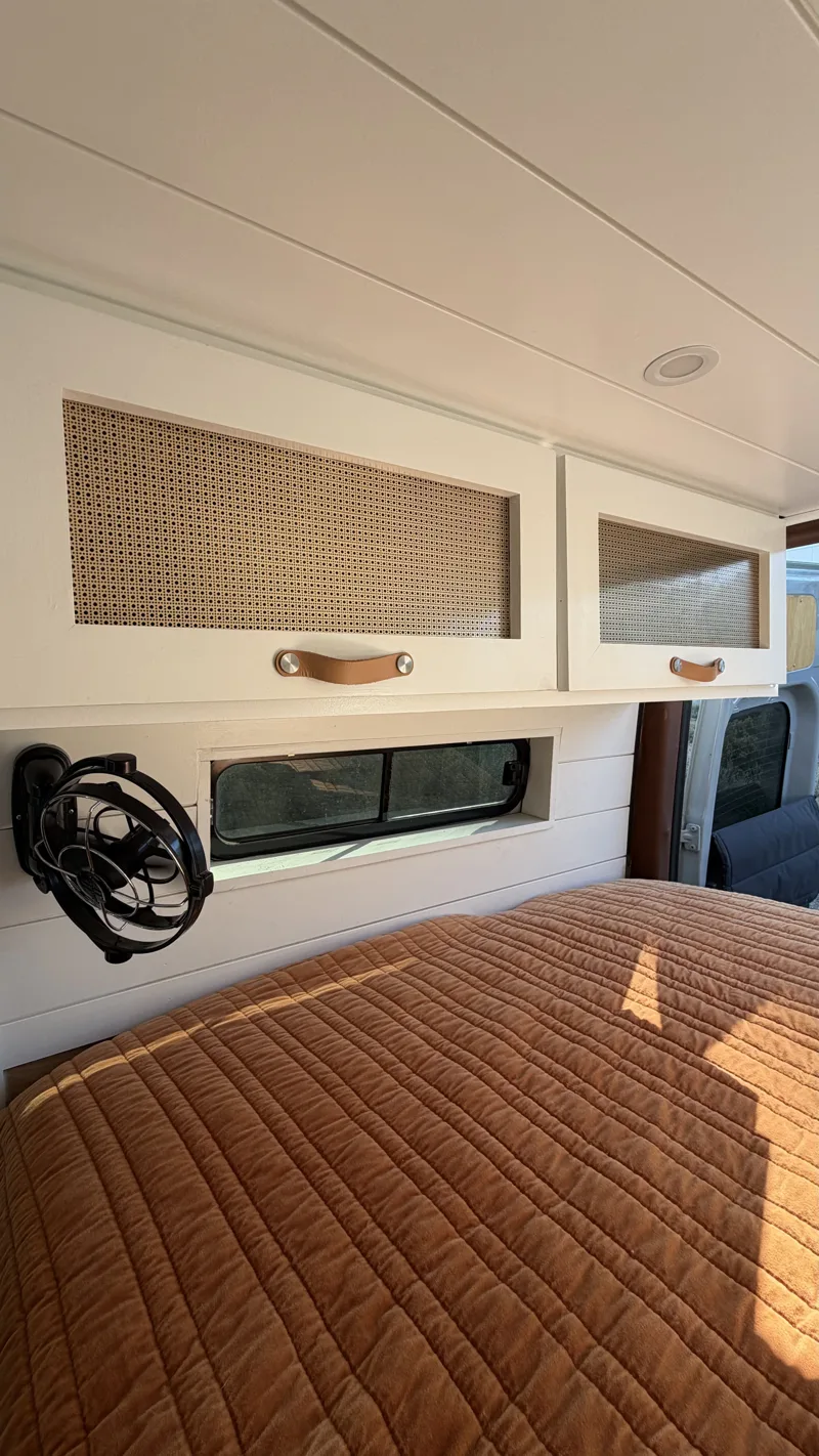 Upper storage cabinets above the bed