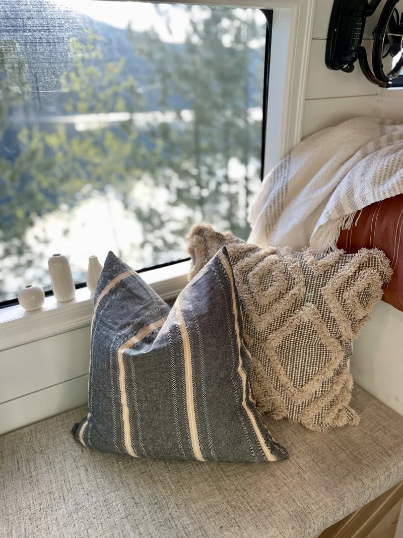 Pillows on the bench beside a mountain view